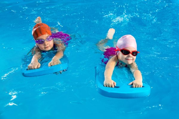 Two,Little,Girls,Having,Fun,In,Pool,Learning,How,To