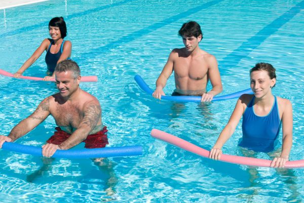 Healthy,Group,Of,People,Exercising,With,Aqua,Tube,In,A